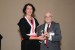 Dr. Nagib Callaos, General Chair, giving Dr. Ruth Bergman award in appreciation for delivering a Great Plenary Keynote Address on "Enterprise IT as Knowledge Keeper"